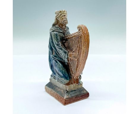 A gray, blue, and brown glazed figure of the Celtic king with his magic harp. The Dagda is an important go in Irish mythology