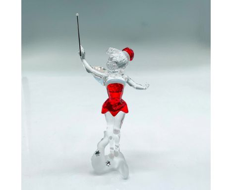 Festive faceted and smooth crystal figure of Tinkerbell holding a magic wand in a red dress and hat. Her wings shimmer in a C
