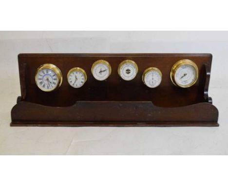 Early 20th Century shelf bracket fitted with an arrangement of modern barometers, clocks, etc., 107cm wide