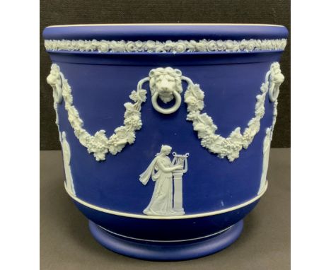 A Wedgwood Blue Jasper jardinière, typically sprigged with classical figures after the antique, below loose ring lion masks s