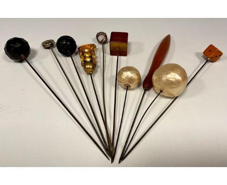 A collection of ten Victorian and later hat, scarf and stick pins, including pale pink faceted round cut possibly topaz toppe