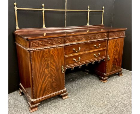 A George III revival mahogany sideboard, neoclassical design, having a brass quarter galleried back above the inverted break-