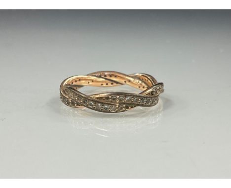 A white stone possibly sapphire twisting interconnected double layer eternity ring, white and rose metal shank, stamped ALE R