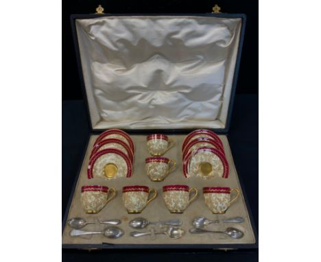A Royal Worcester cased cabaret set, floral gilt decoration on a cream and burgundy ground, printed marks, with six silver co