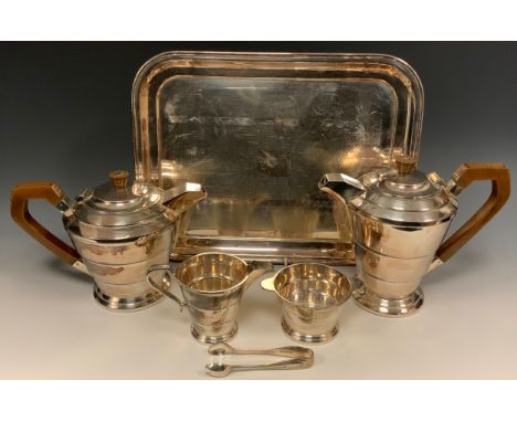 An Art Deco E.P.N.S four piece tea service, comprising teapot, hot water pot, milk jug and sugar basin, of stepped geometric 
