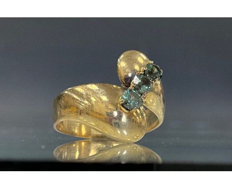 An unusual blue stone possibly tourmaline dress ring, overlapping yellow metal shank, stamped  333, size Q, 3g gross 