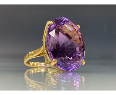 A large oval amethyst ring, approx 19mm x 16mm, 18ct gold shank, stamped 750, size K, 8.5g gross 