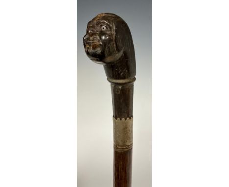 A carved horn handled walking stick, as a bald mans head, inset glass eyes, metal ferule, banded tapering shaft, 86cm long. 