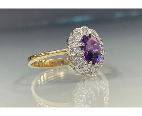 A diamond and amethyst cluster ring, central oval amethyst approx 1.45ct, above six round brilliant cut diamond accented coll