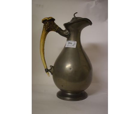 A pewter ewer and cover, with antler handle, 27 cm high, an inlaid mahogany mantel clock, the dial signed W F Johnson Leicest