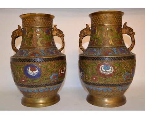 A pair of Chinese champlevé enamel and gilt vases, decorated stylised flowers and foliage, with mask handles, 30 cm high (2) 