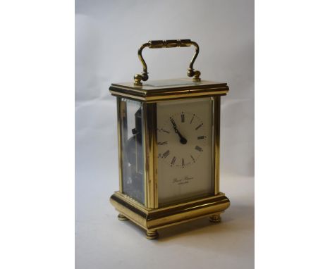 A carriage clock, the 5.5 cm wide enamel dial with Roman numerals, striking on a bell, in a brass four pillar case, 15 cm hig