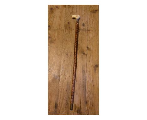 A carved ivory and silver coloured metal mounted walking stick, inscribed T Richards on the collar, 89 cm long