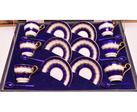 An Aynsley coffee set, with blue and gilt rim decoration, for six place settings, with matching silver and enamel coffee spoo
