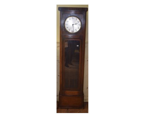 A 20th century longcase clock, the 27 cm diameter silvered dial with Arabic numerals, in an oak case, with a glazed tunk door