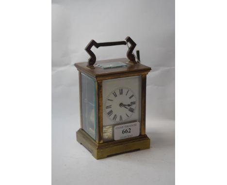 A carriage clock, having a brass four pillar case, striking on a gong, with presentation plaque to dial, 15 cm high    Condit