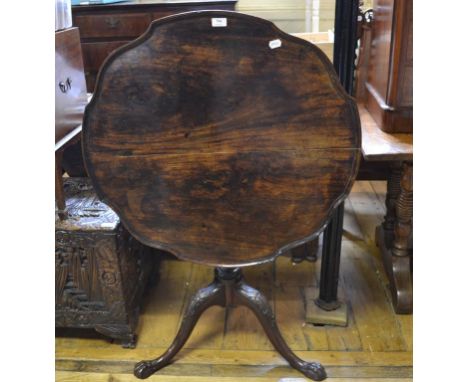 A mahogany tripod table, the shaped top with piecrust edge on a carved tripod base with claw feet, possibly Irish, 81 cm diam