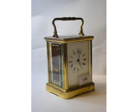 A carriage timepiece, the 6.5 cm wide enamel dial with Roman numerals, in a brass four pillar case, 17 cm high   Condition re