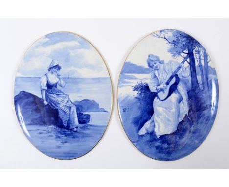 A Doulton Burslem Blue Children Series wall plaque, decorated a girl with a book by the coastline, with gilt rim, 35.5 x 27.5