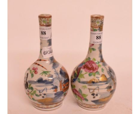 A pair of Chinese famille rose porcelain bottle vases, decorated birds, insects and flowers, 17 cm high (2)    Condition repo