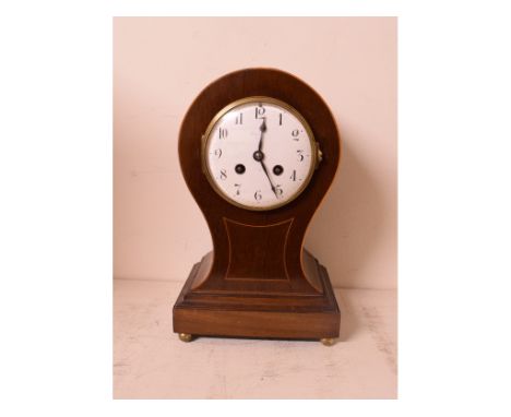An Edwardian mantle clock, the 10 cm diameter enamel dial with Arabic numerals, fitted an eight day movement, in a mahogany b