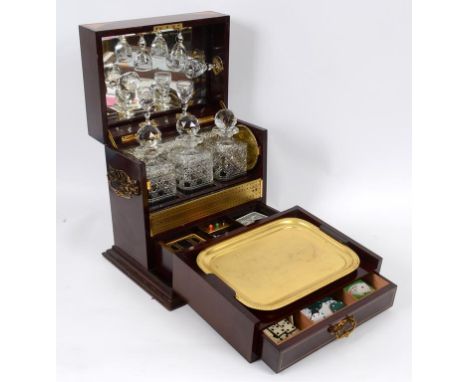 An Edwardian combined tantalus and games compendium type inlaid mahogany box, the interior fitted three glass decaters, six g