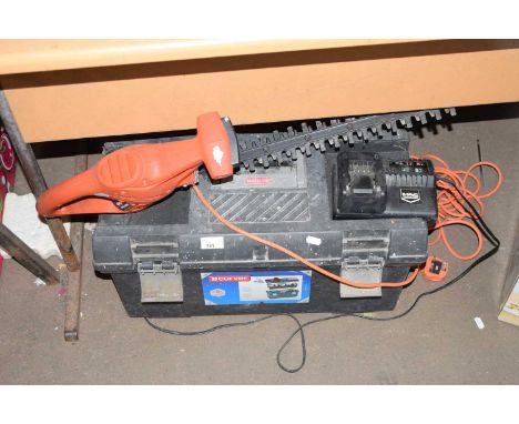 Electric hedge trimmer together with a toolbox and contents