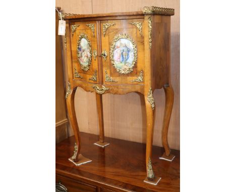 A Louis XV style ormolu-mounted kingwood small commode, enclosed by a pair of doors with porcelain panels W.50cm