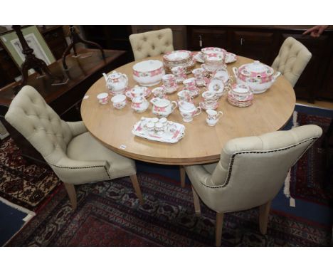 A Neptune light oak circular topped dining table and a set of four Neptune buttoned back dining chairs Table diameter 150cm