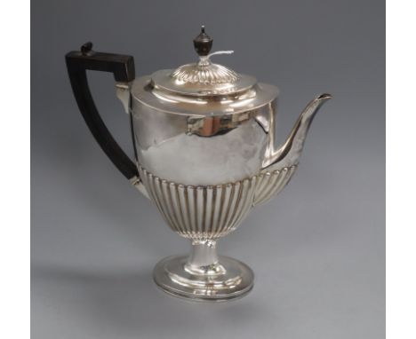 A Victorian demi fluted silver pedestal coffee pot by Edward Hutton, London, 1884, height 28.5cm, gross 25.5oz.