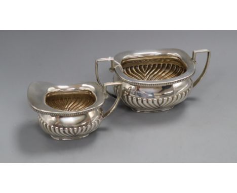 A late Victorian demi fluted silver cream jug and matching sugar bowl, William Hutton &amp; Sons, London, 1899, 14.5oz.