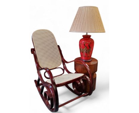 A contemporary Indonesian hardwood circular occasional table; a contemporary table lamp decorated with cranes, with shade; a 