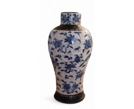 A late 19th century Chinese crackle glazed vase, decorated in underglazed blue with scrolling foliage and birds,&nbsp;moulded
