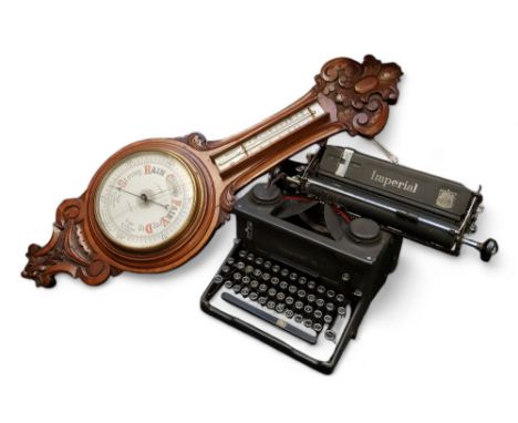 A Victorian oak aneroid barometer marked W.E.Watts, Nottingham; an early 20th century Imperial 58 typewriter (2)