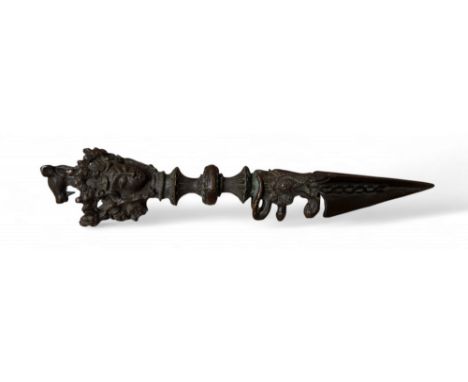 A Tibetan Buddhist bronze phurba, the pommel cast with the three faces of Vajrakīla, 19cm long