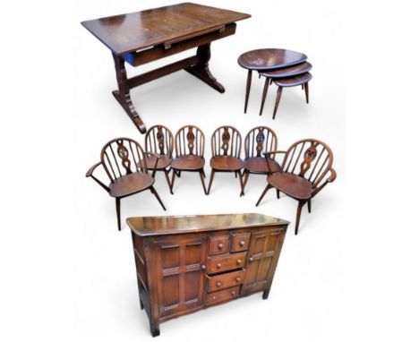 An Ercol suite including four fleur-de-lys model dining chairs and two carvers; a drawer-leaf dining table; an Ercol pebble m