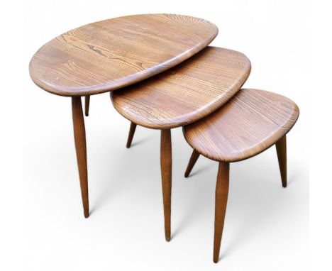 A nest of three mid 20th century Ercol golden dawn 'pebble' model occasional tables