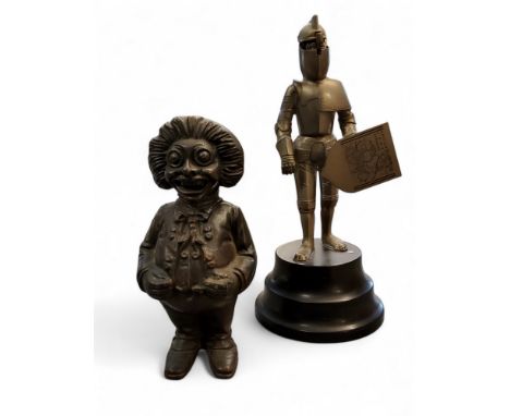 A cast-metal 'Golly' money bank, probably John Harper Ltd,  16cm high;   a novelty musical wind-up lighter, in the form of a 