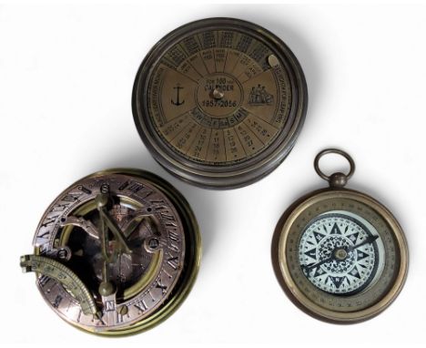 A contemporary brass desk calendar, for 100 YEARS 1957 - 2056;&nbsp; &nbsp;a contemporary compass, the back inscribed A Journ