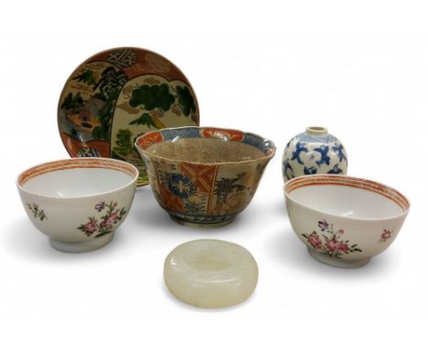 A pair of 18th century&nbsp; Chinese tea bowls, decorated in the famiile rose manner, with scattered floral sprigs, c.1770;&n