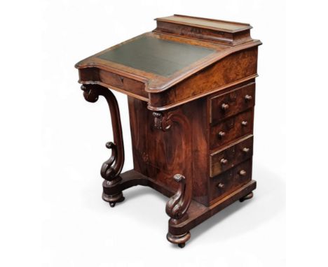 A Victorian walnut Davenport desk, hinged superstructure enclosing stationery divisions, the hinged sloping top with inset to