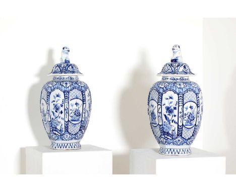 Two pairs of delftware blue and white vases,20th century, of octagonal shape, one pair with covers, all with typical painted 