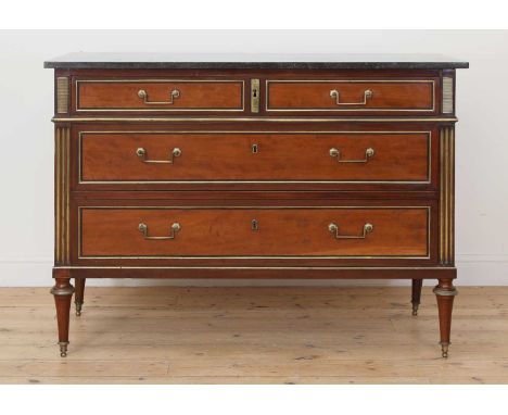 A Louis XVI mahogany commode,the grey marble top over three long drawers with brass mounts and handles, within gilt fluted co