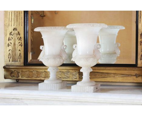 A pair of Italian neoclassical alabaster lamp vases,c.1930, Volterra, each of campana shape, with carved decoration and a lam