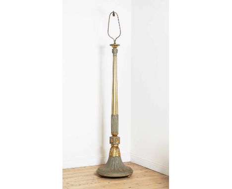 A grey and gold painted wooden standard lamp,early 20th century, the column fluted above carved stiff leaves, the base carved