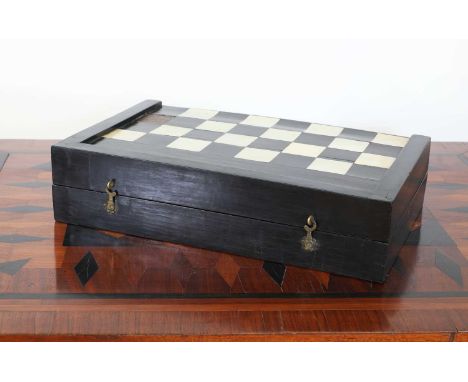 An ebony folding games box,17th/18th century, the exterior with a chess board with ivory squares, the interior for backgammon