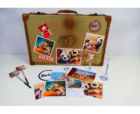 Steiff - A Steiff point of sale shop display - A vintage style suitcase covered in stickers and measuring 57 x 37 x 17 cm and