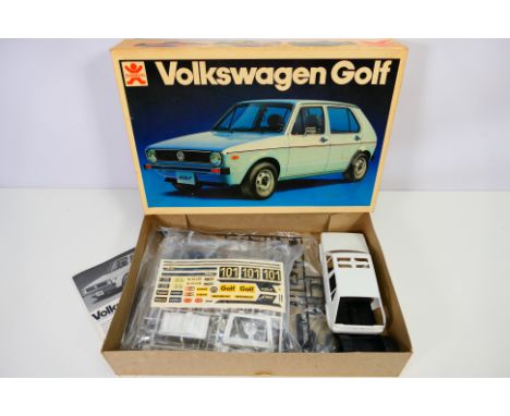 Bandai- A boxed vintage 1977 Bandai #8029 1:20 scale Volkswagen Golf. The kit appears to be in Mint condition with loose part