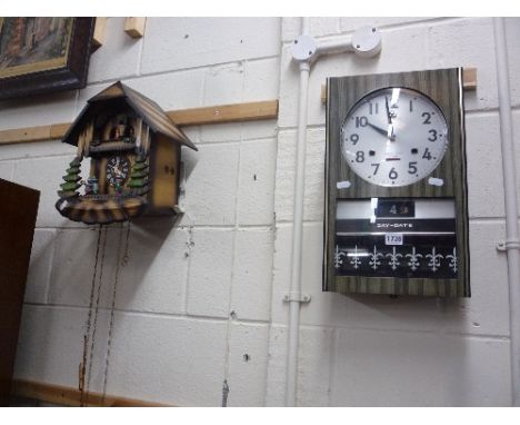 A RHYTHM 30 DAY WALL CLOCK, and a modern cuckoo clock (two pendulums, one key)