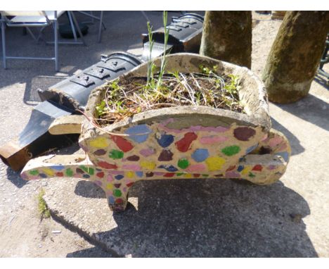 A COMPOSITE GARDEN PLANTER, in the shape of a wheelbarrow